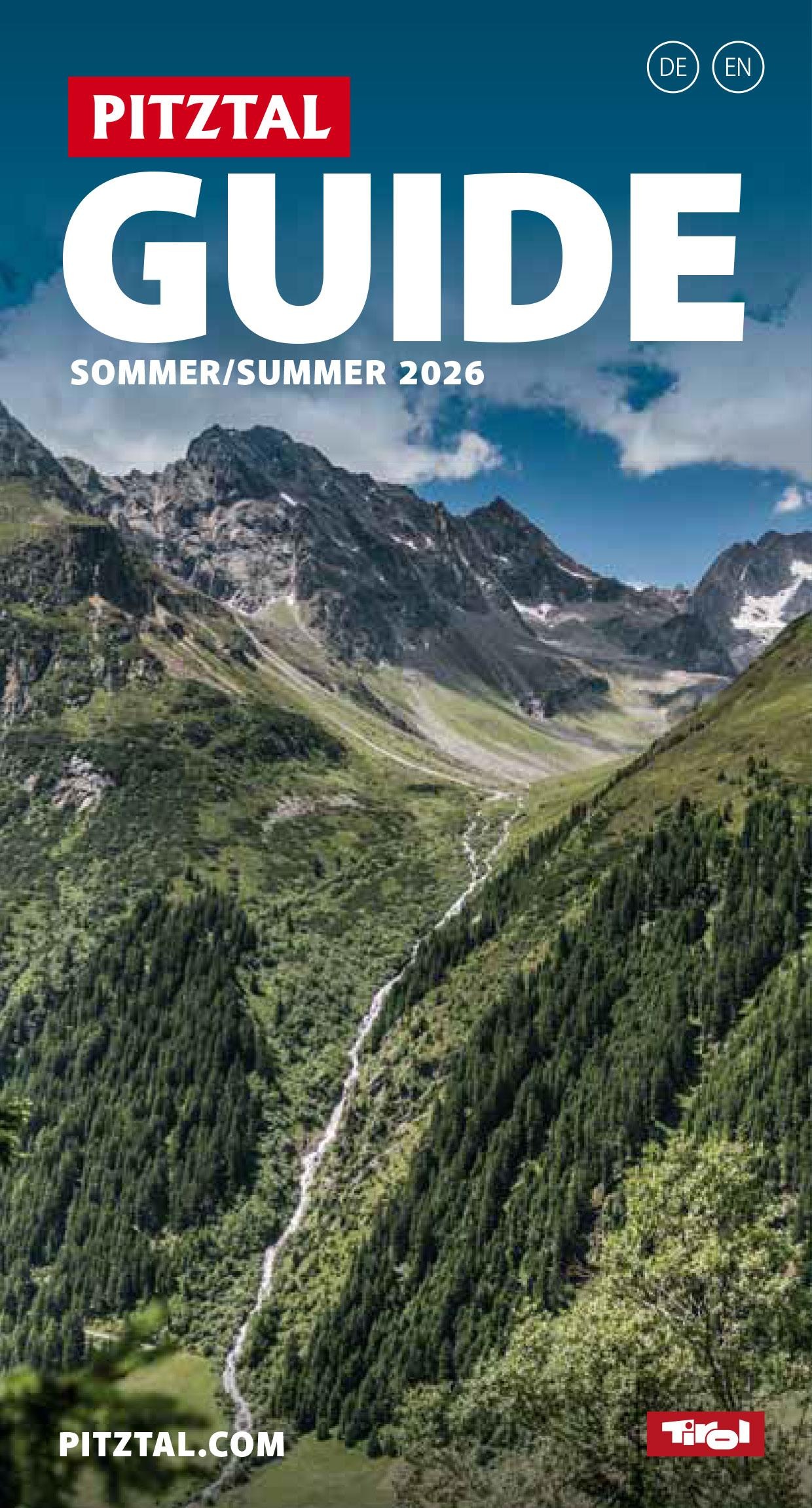 A beautiful view of the Pitztal with green meadows and majestic mountains. A clear sky complements the idyllic landscape.