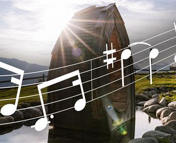 A picturesque landscape with a wooden structure and gentle hills. Musical notes are visible in the foreground.
