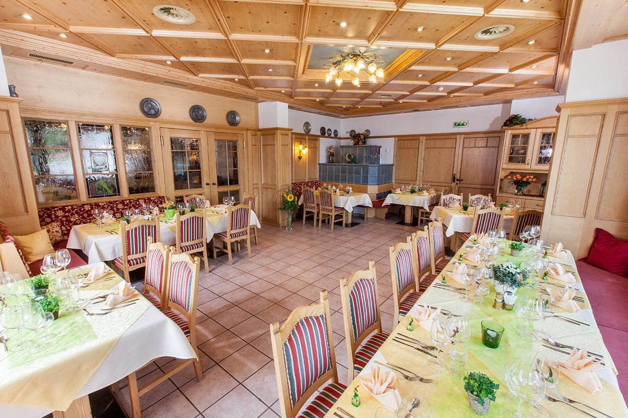 A cozy restaurant with wood decor and friendly-set tables. The atmosphere is inviting and warm.