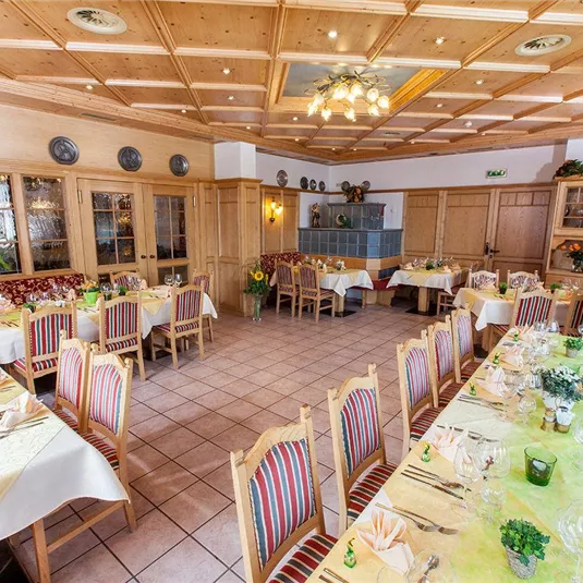 A cozy restaurant with wood decor and friendly-set tables. The atmosphere is inviting and warm.