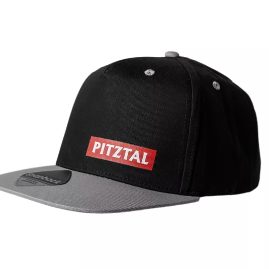 A black cap with a gray underside of the brim. On the front, there is the lettering "PITZTAL" in red.
