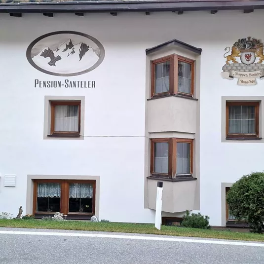 Ein charmantes Gebäude mit traditioneller Architektur und klaren Linien. Das Haus hat kleine Fenster und einen gepflegten Vorgarten.